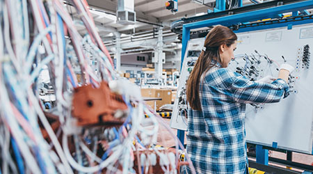 Woman working in distribution center on a cable board