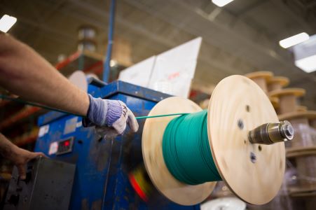 Warehouse worker respools wire